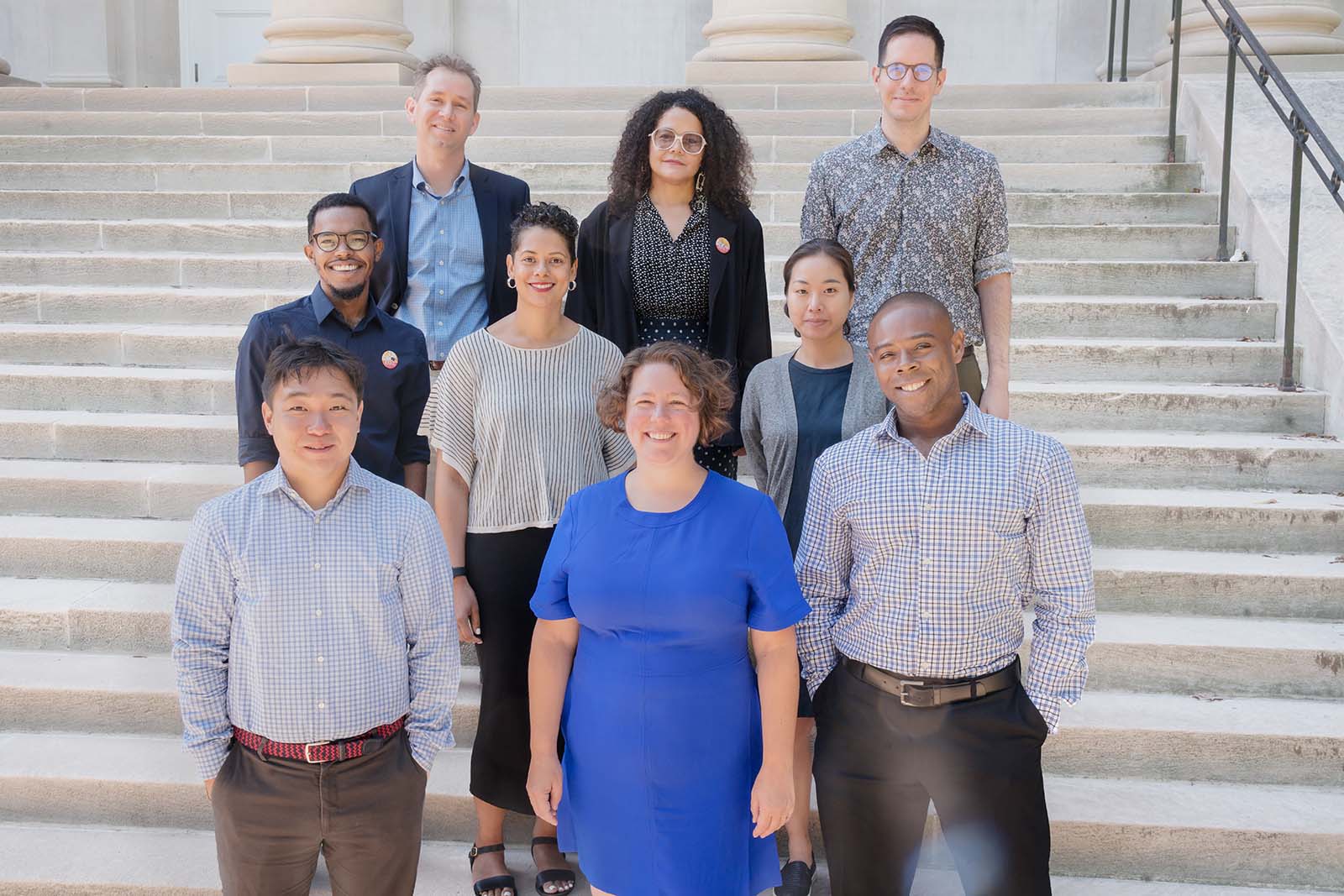 New arhu staff standing in front of a stair