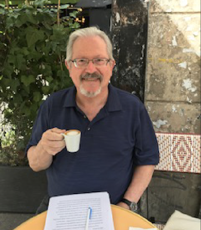 Brian Richardson in a cafe with coffee.